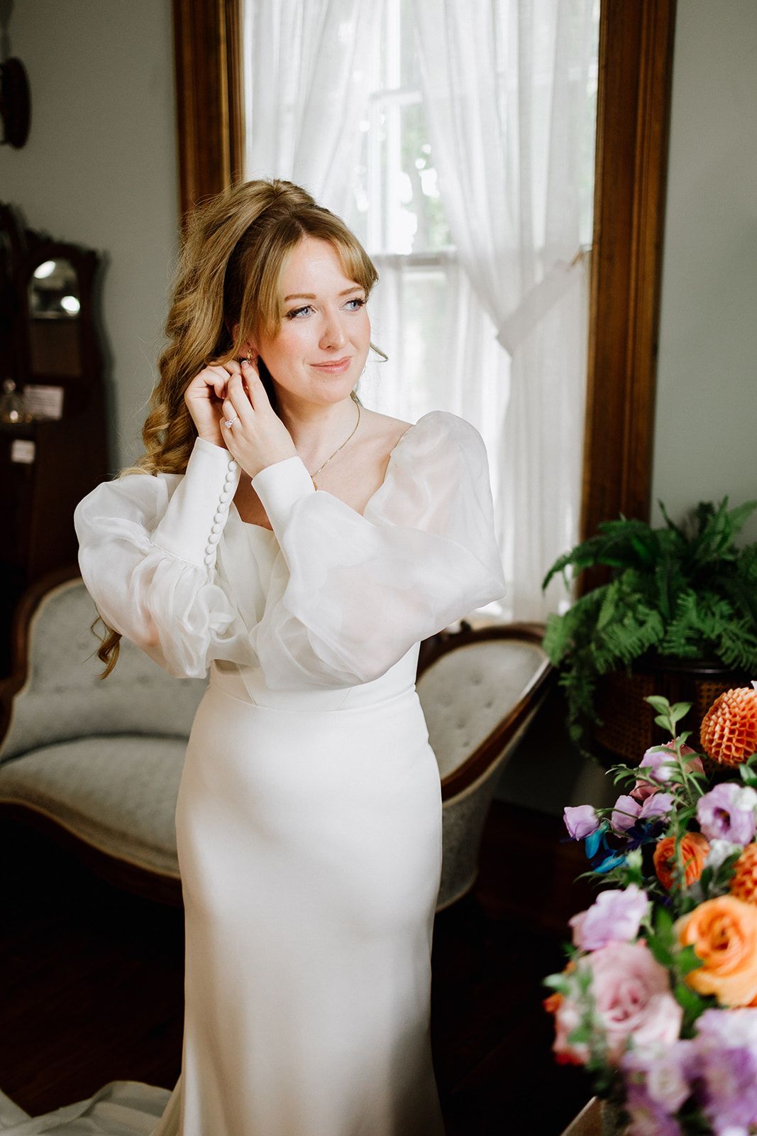 Bride adjusting an earring