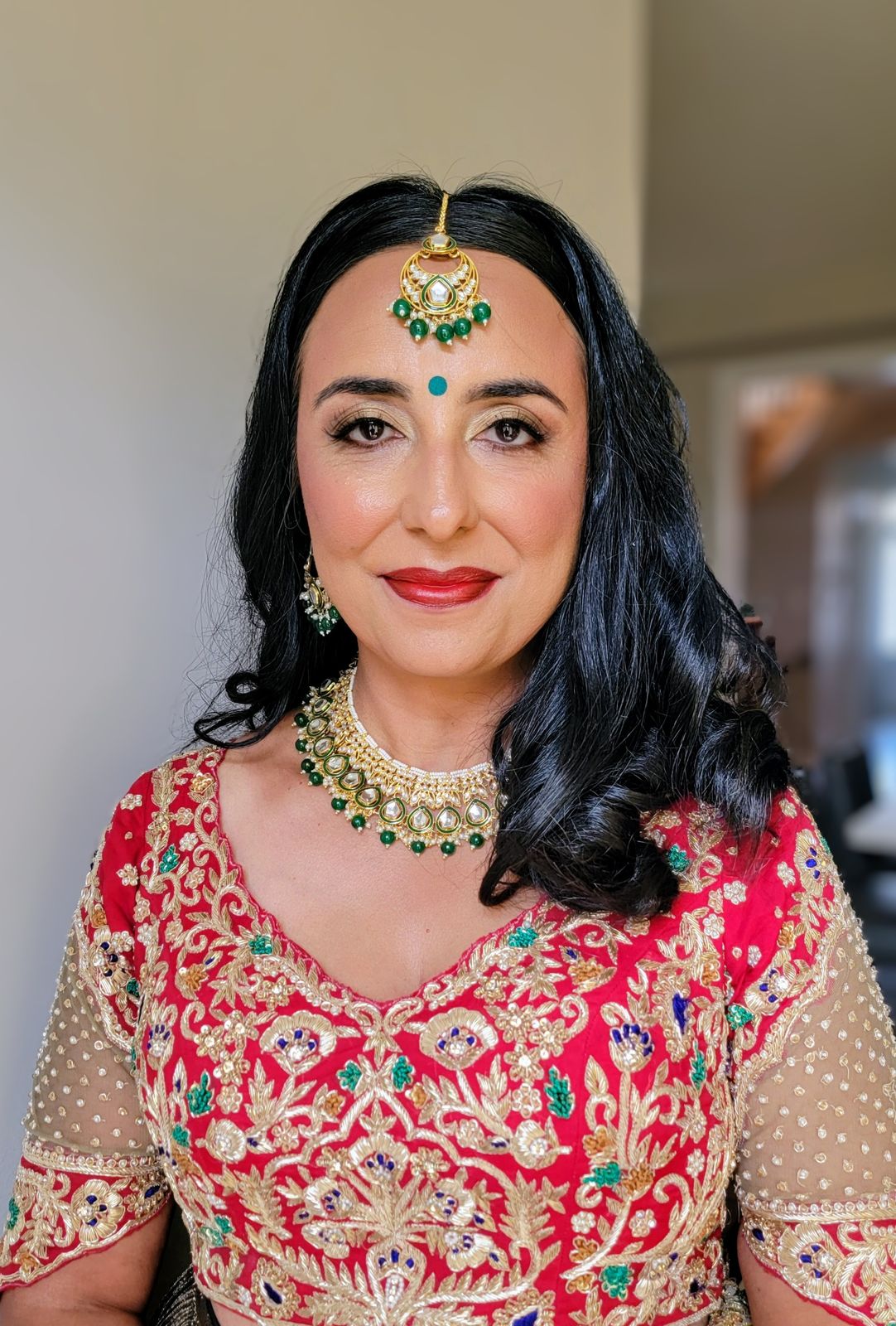 South Asian bride in red with maang tikka