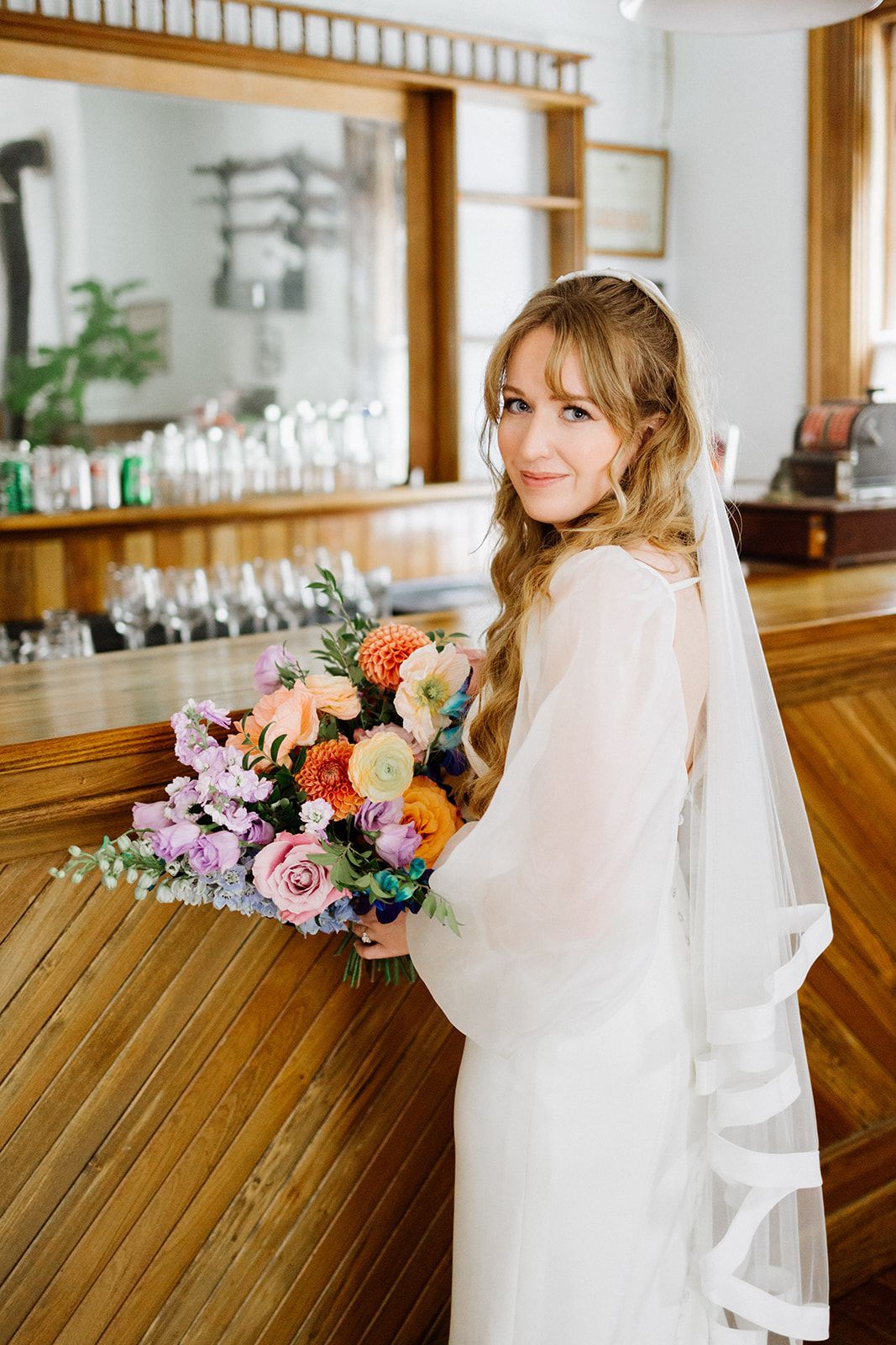 Bride holding a colourful bouquet