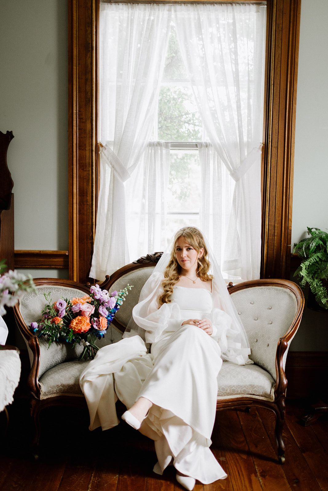 Bride seated by a window
